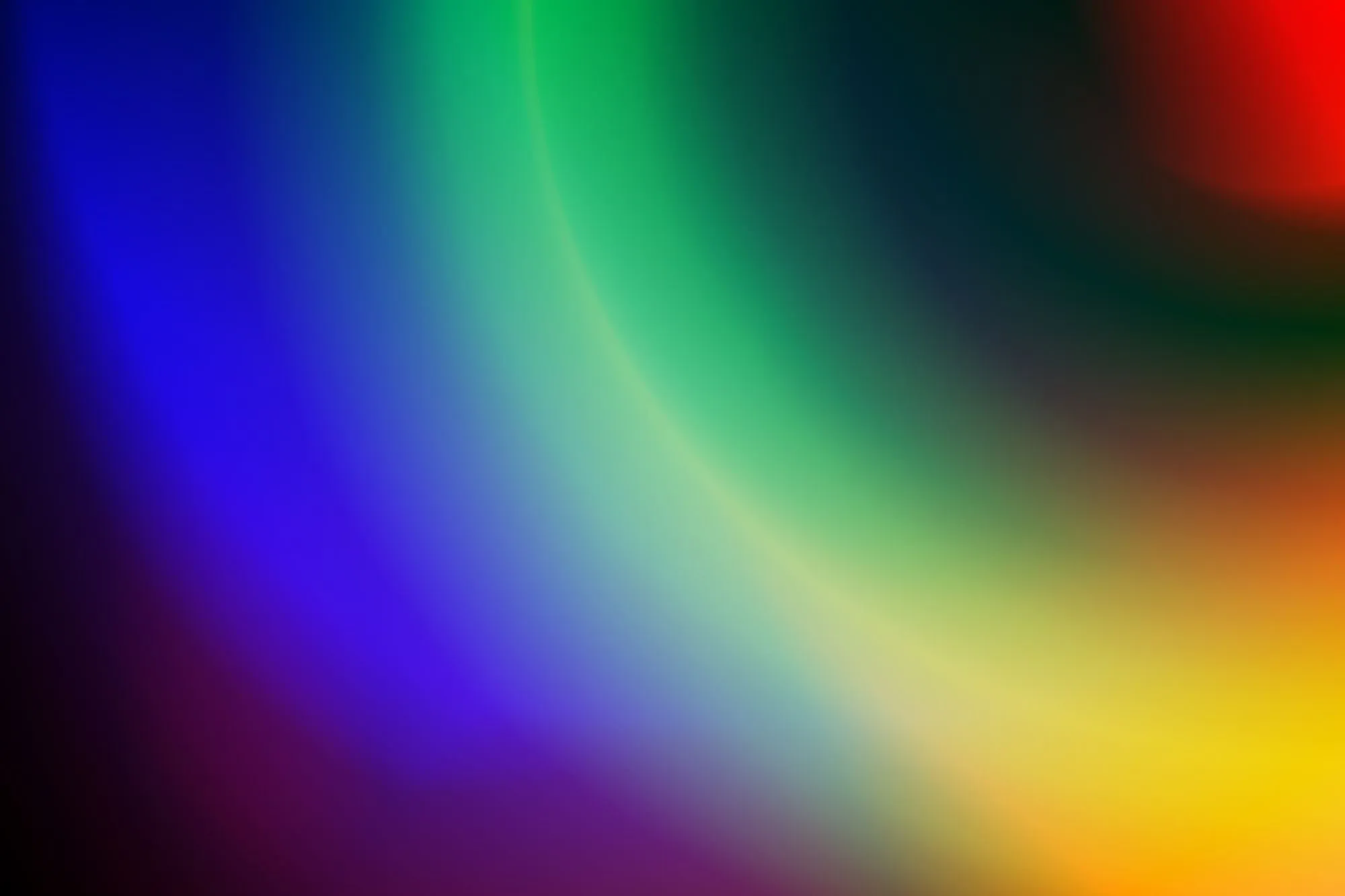 A dark gradient turning through blue, green and yellow